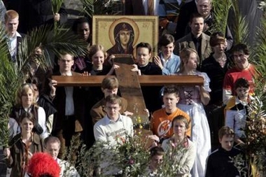 Het Kruis van de Wereld Jongeren Dagen en de Icoon van Maria worden in palmprocessie meegenomen.